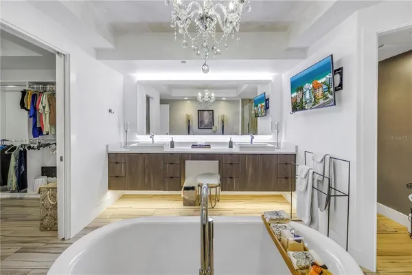 a bathroom with a tub sink and mirror