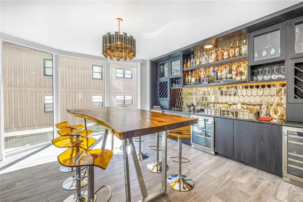 a view of a dining room with furniture and chandelier