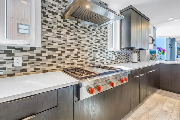 a kitchen with stainless steel appliances a stove a sink and a refrigerator