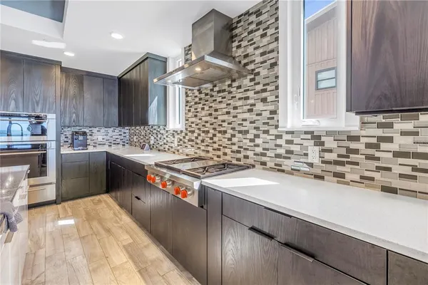 a kitchen with a sink stove and cabinets