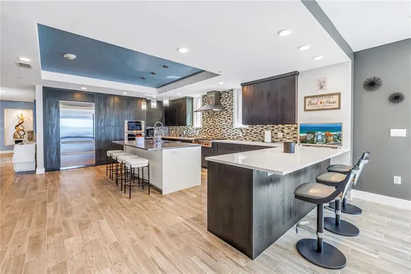 a kitchen with stainless steel appliances kitchen island granite countertop a sink and cabinets