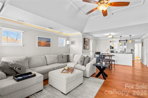 a living room with furniture and kitchen view