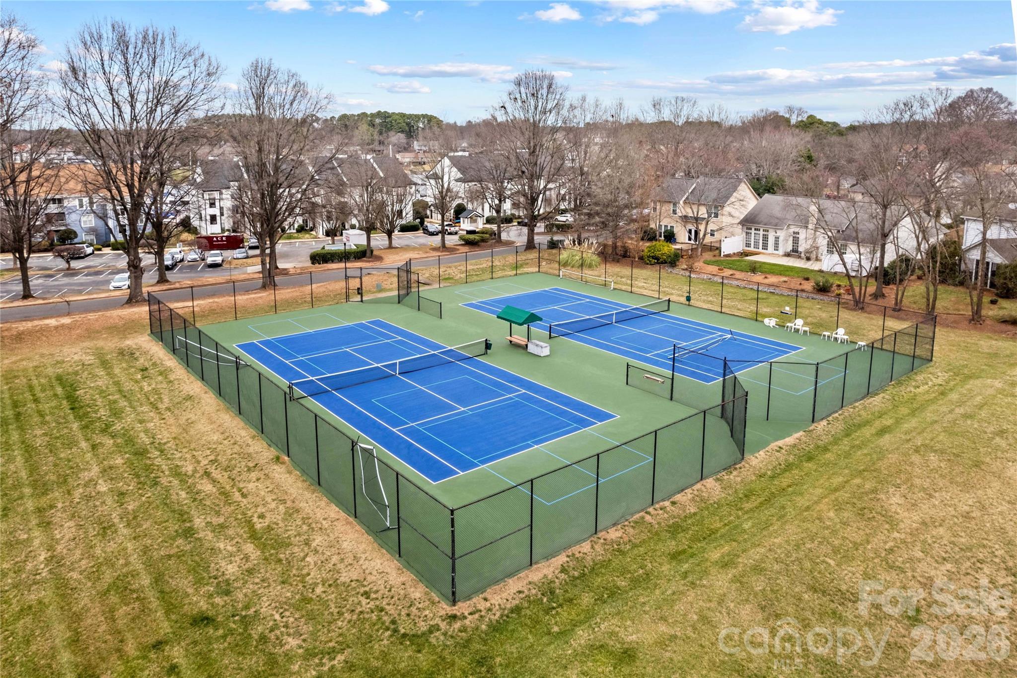 18797 Vineyard Point Lane Cornelius, NC 28031 - Photo 32 of 36 a view of a tennis ground with large trees