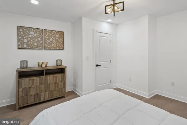 a room with a bed and a chandelier