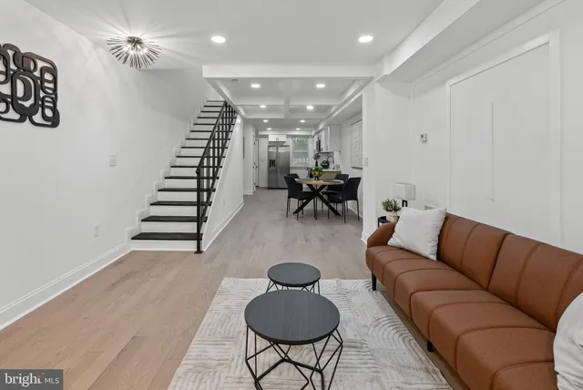 a living room with furniture and a chandelier