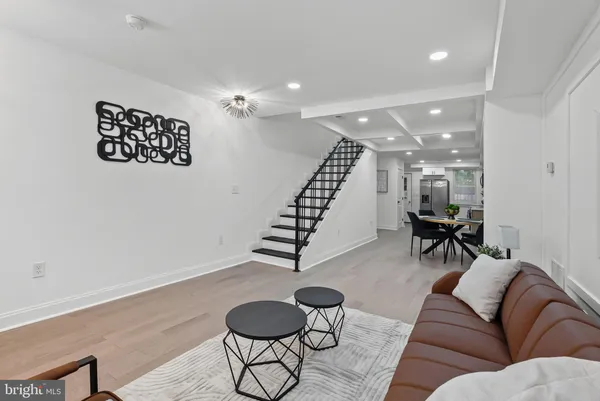 a living room with furniture and a potted plant