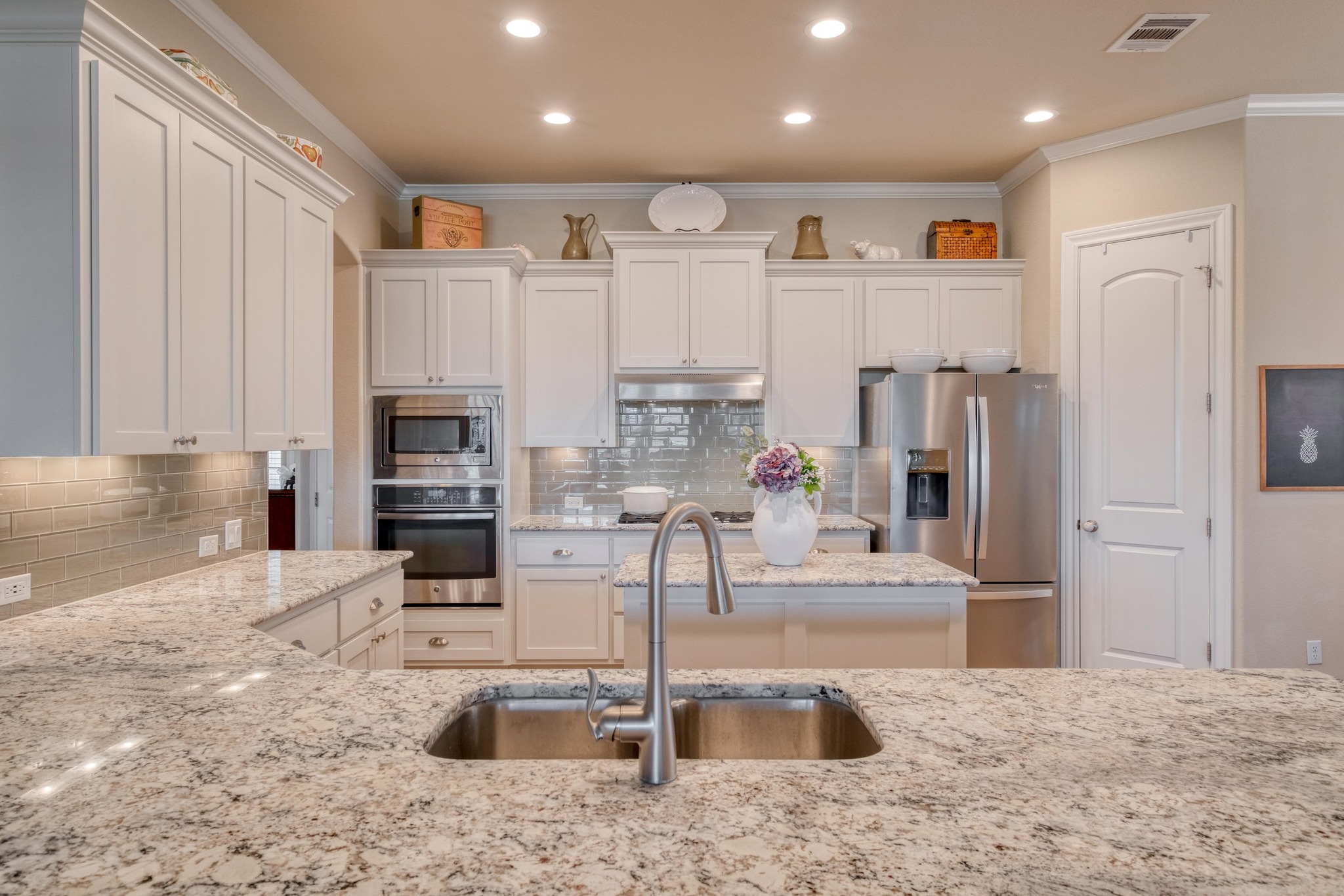 3204 Venezia View Leander, TX 78641 - Photo 6 of 28 Kitchen featuring granite countertops, white cabinets, and appliances with stainless steel finishes