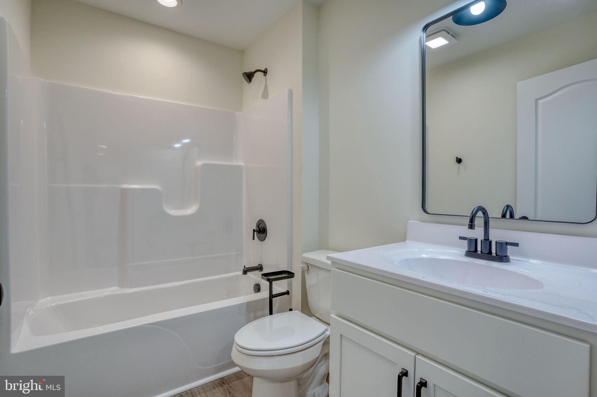 205 Charles Way Georgetown, DE 19947 - Photo 11 of 31 a bathroom with a sink toilet and a bathtub