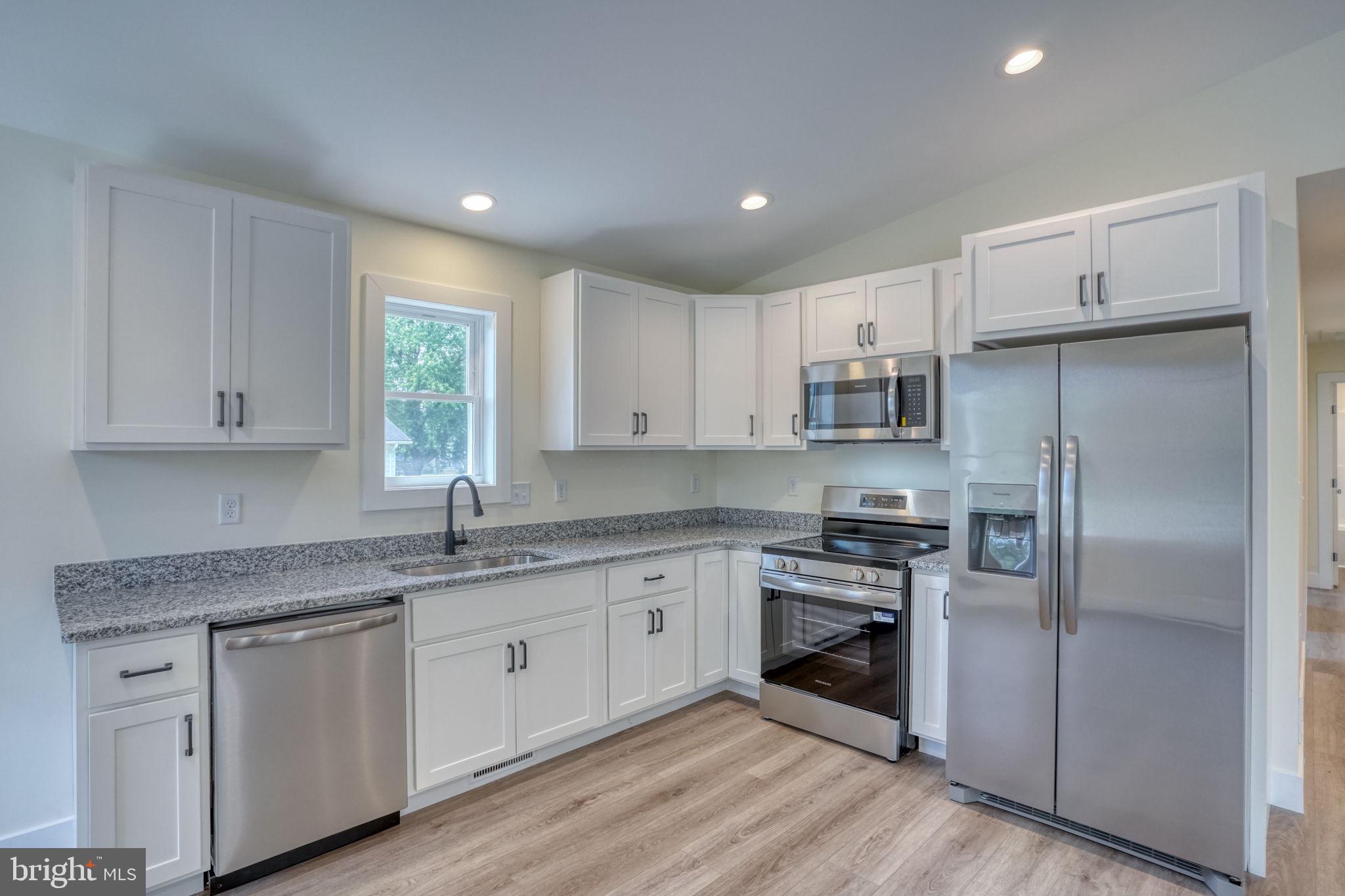 205 Charles Way Georgetown, DE 19947 - Photo 6 of 31 a kitchen with a refrigerator sink and cabinets