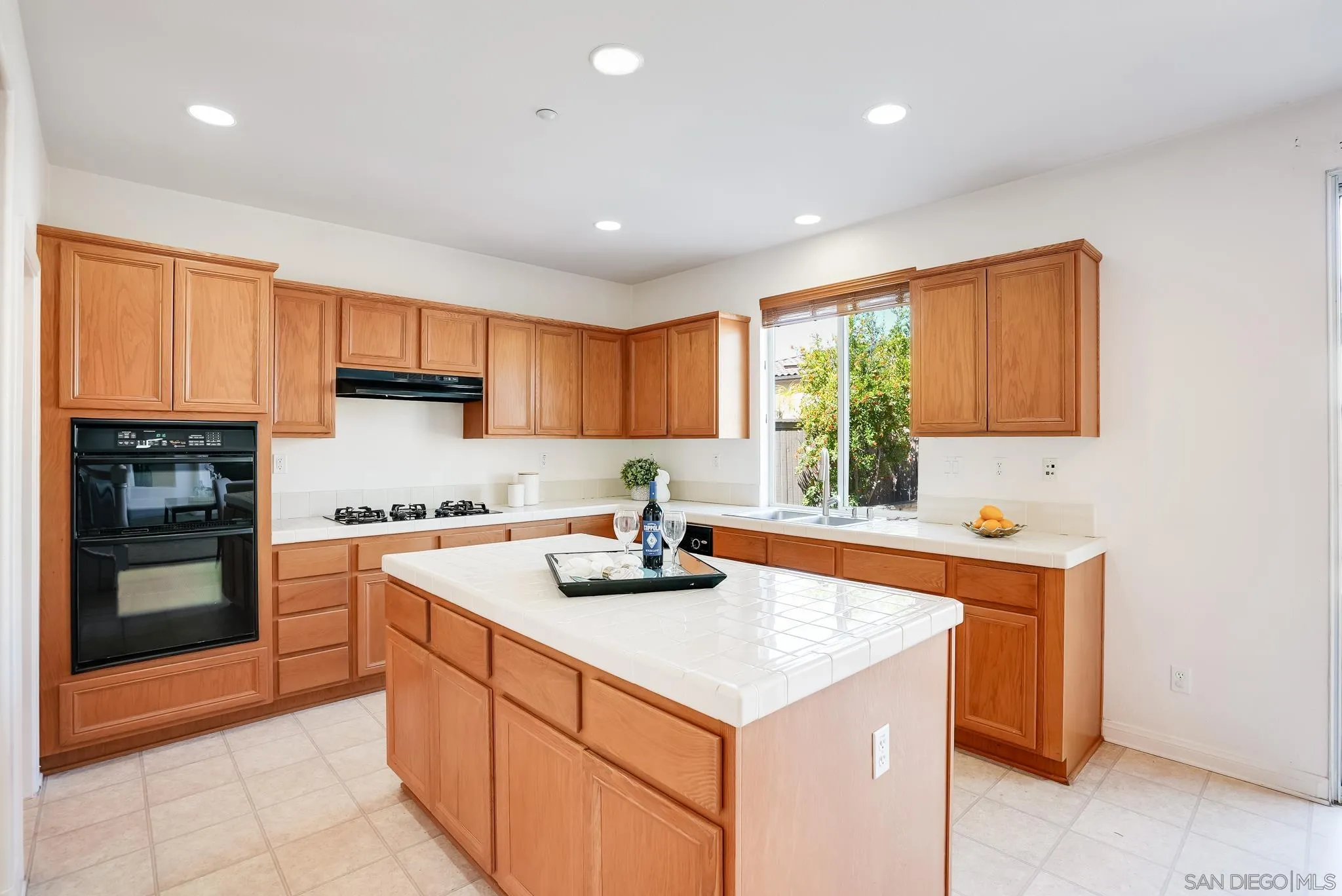 17048 Ralphs Ranch Road San Diego, CA 92127 - Photo 12 of 26 a kitchen with stainless steel appliances granite countertop a sink stove and refrigerator