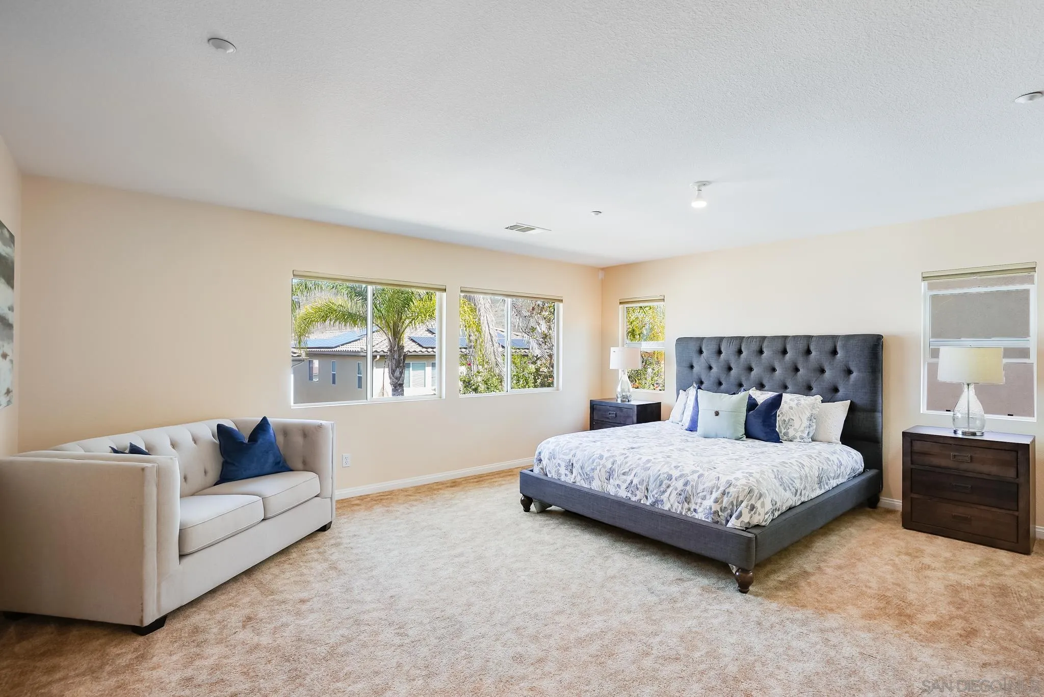17048 Ralphs Ranch Road San Diego, CA 92127 - Photo 20 of 26 a bedroom with a bed and a couch with window