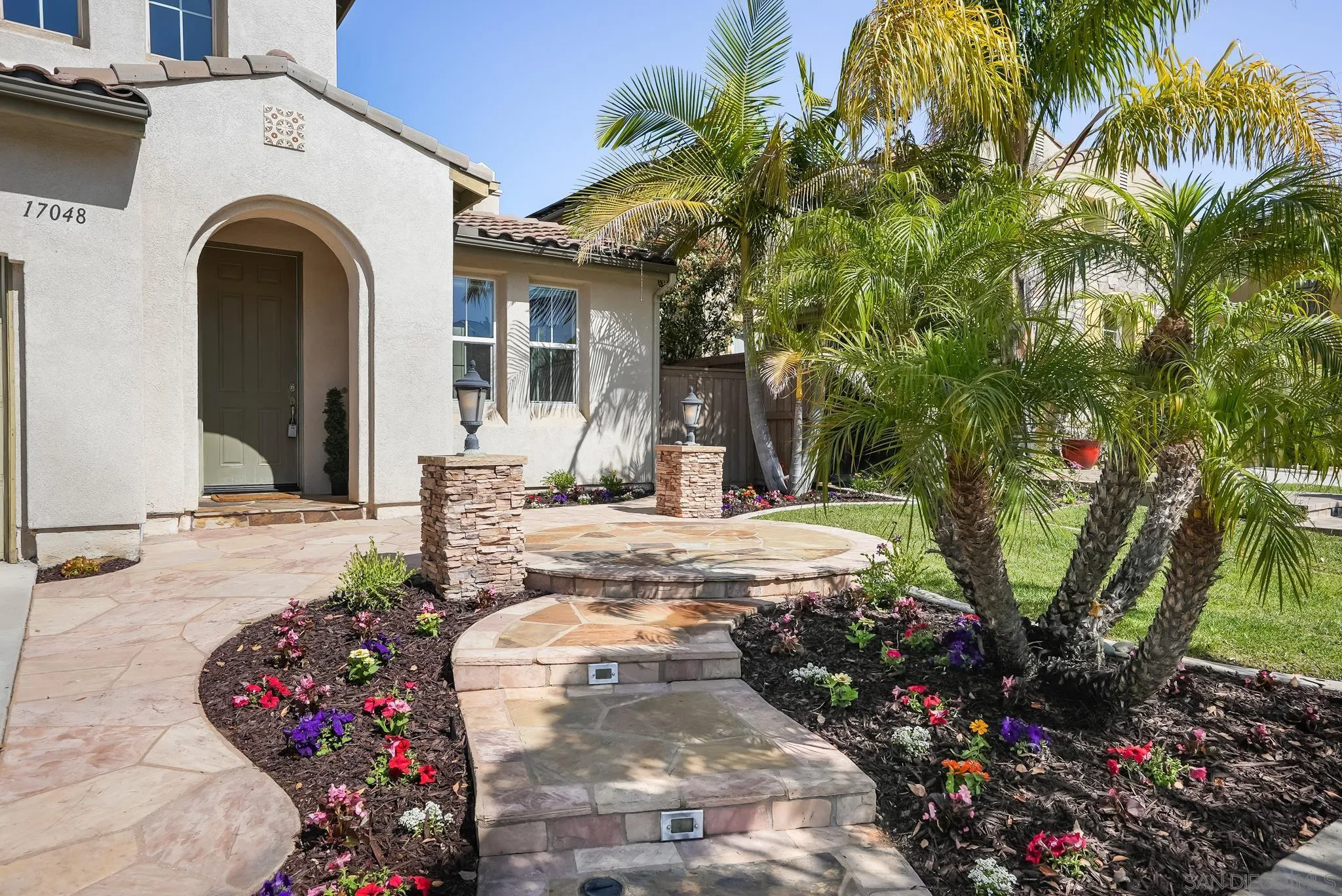17048 Ralphs Ranch Road San Diego, CA 92127 - Photo 2 of 26 a front view of a house with a yard