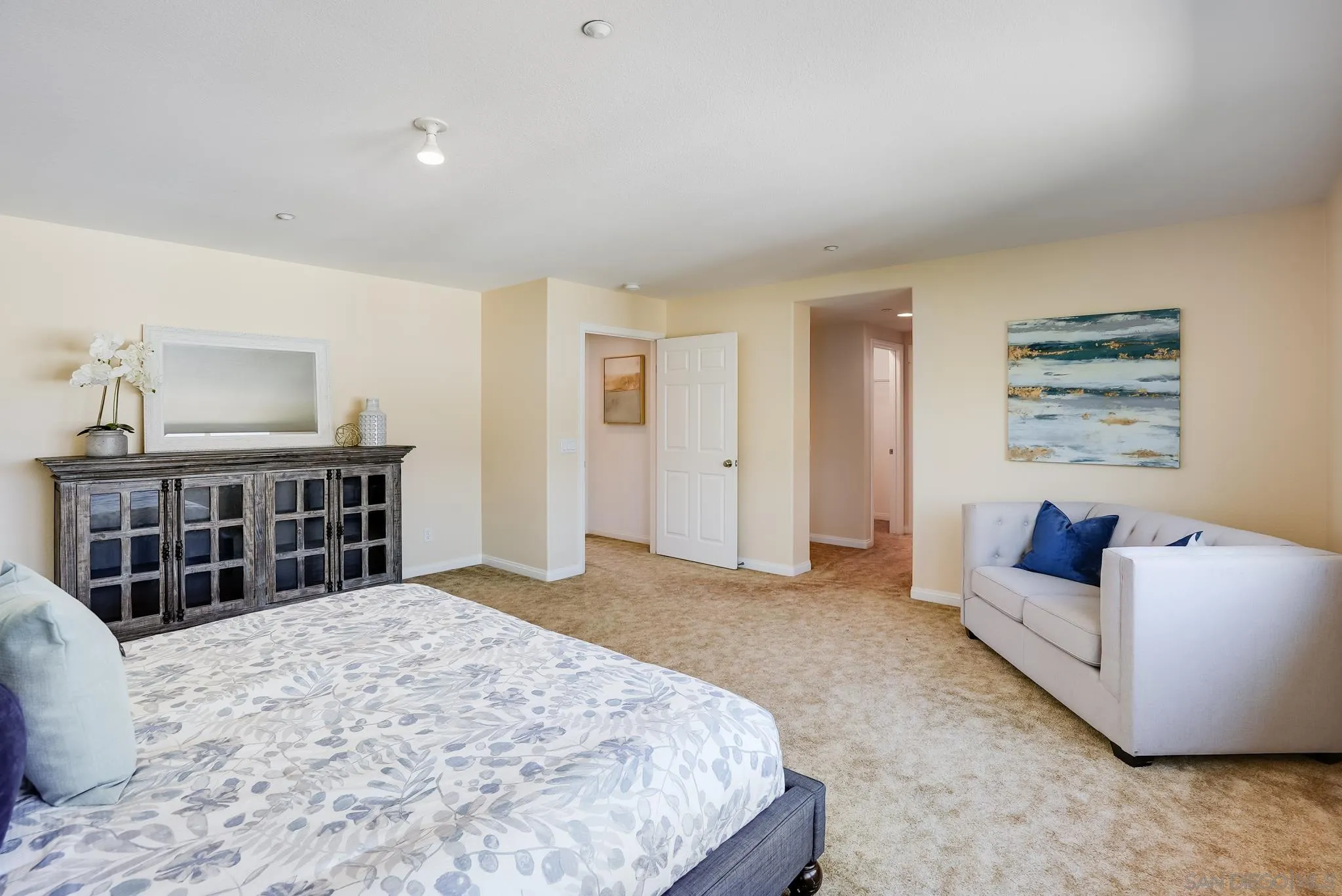 17048 Ralphs Ranch Road San Diego, CA 92127 - Photo 21 of 26 a bedroom with a bed and a couch