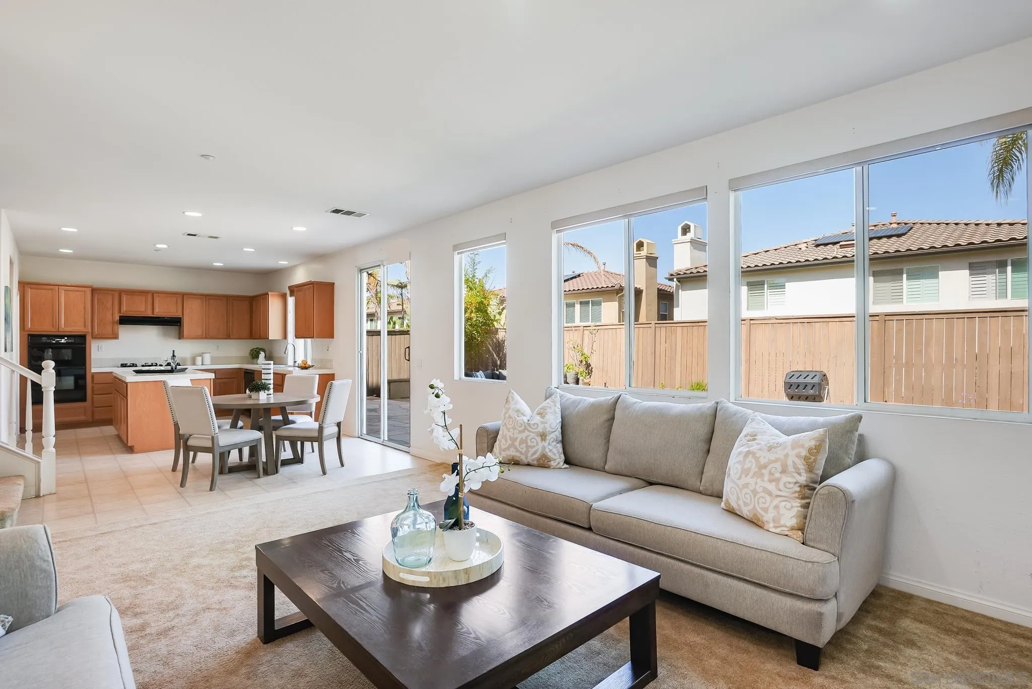 17048 Ralphs Ranch Road San Diego, CA 92127 - Photo 9 of 26 a living room with furniture kitchen view and a wooden floor