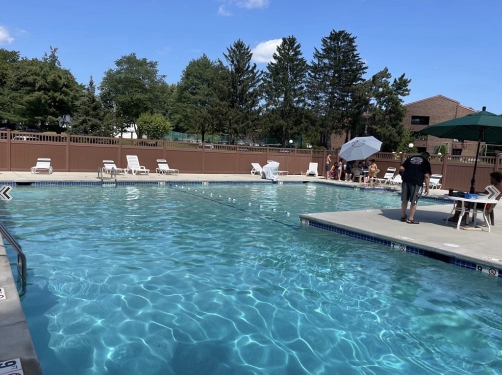 9 Davis Road, Unit C1 Acton, MA 01720 - Photo 1 of 20 a view of a swimming pool with a yard and sitting area