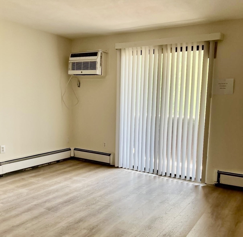 9 Davis Road, Unit C1 Acton, MA 01720 - Photo 11 of 20 an empty room with wooden floor and windows
