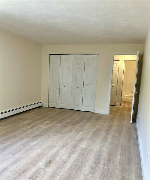 9 Davis Road, Unit C1 Acton, MA 01720 - Photo 13 of 20 a view of an empty room and wooden floor