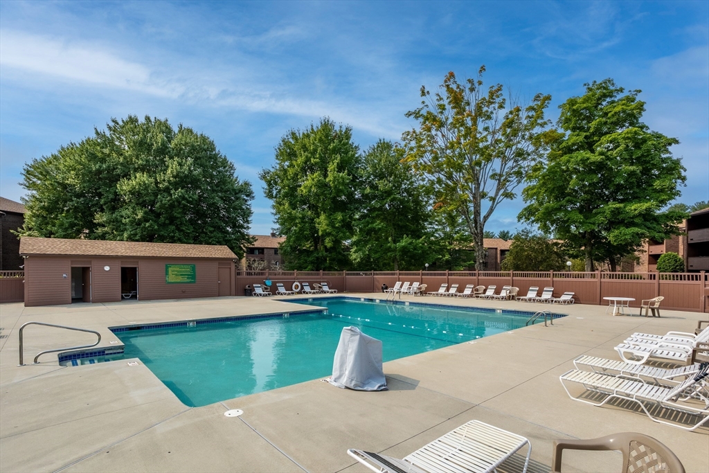 9 Davis Road, Unit C1 Acton, MA 01720 - Photo 2 of 20 a view of a swimming pool with a patio