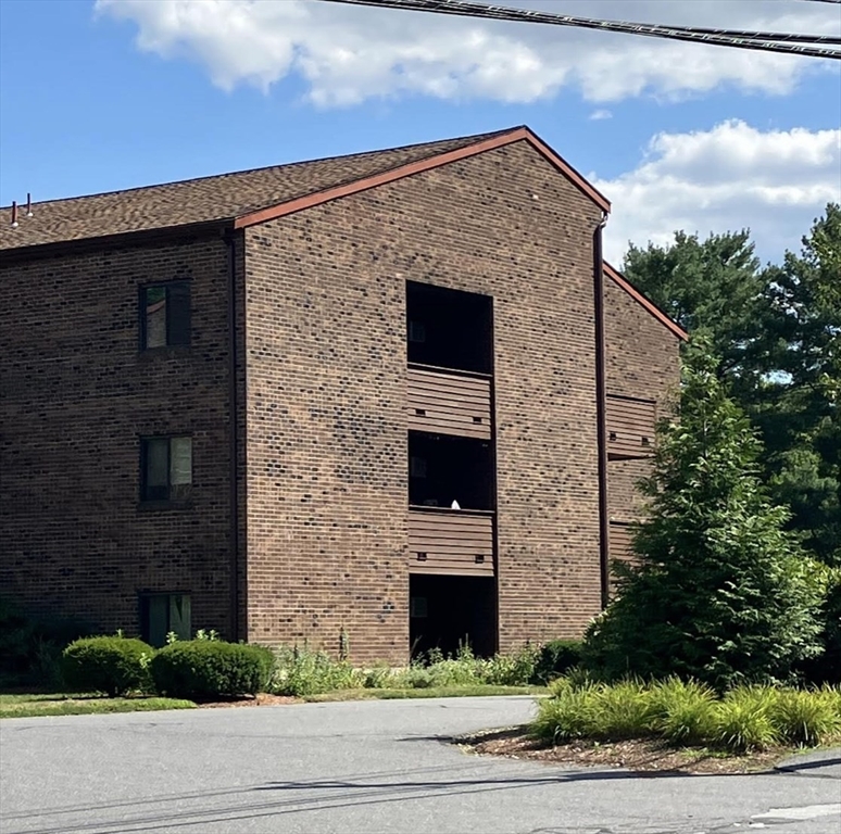 9 Davis Road, Unit C1 Acton, MA 01720 - Photo 7 of 20 a front view of a house with a yard and garage