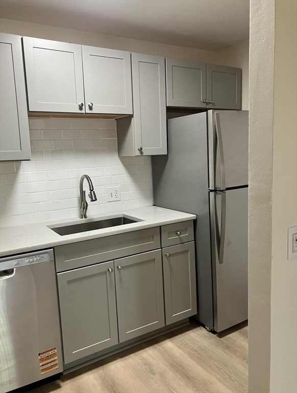9 Davis Road, Unit C1 Acton, MA 01720 - Photo 10 of 20 a kitchen with cabinets and a refrigerator