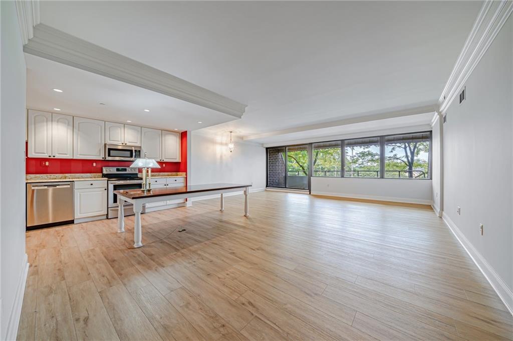 750 Washington Road, Unit 211 Pittsburgh, PA 15228 - Photo 3 of 19 a room with wooden floors and kitchen view