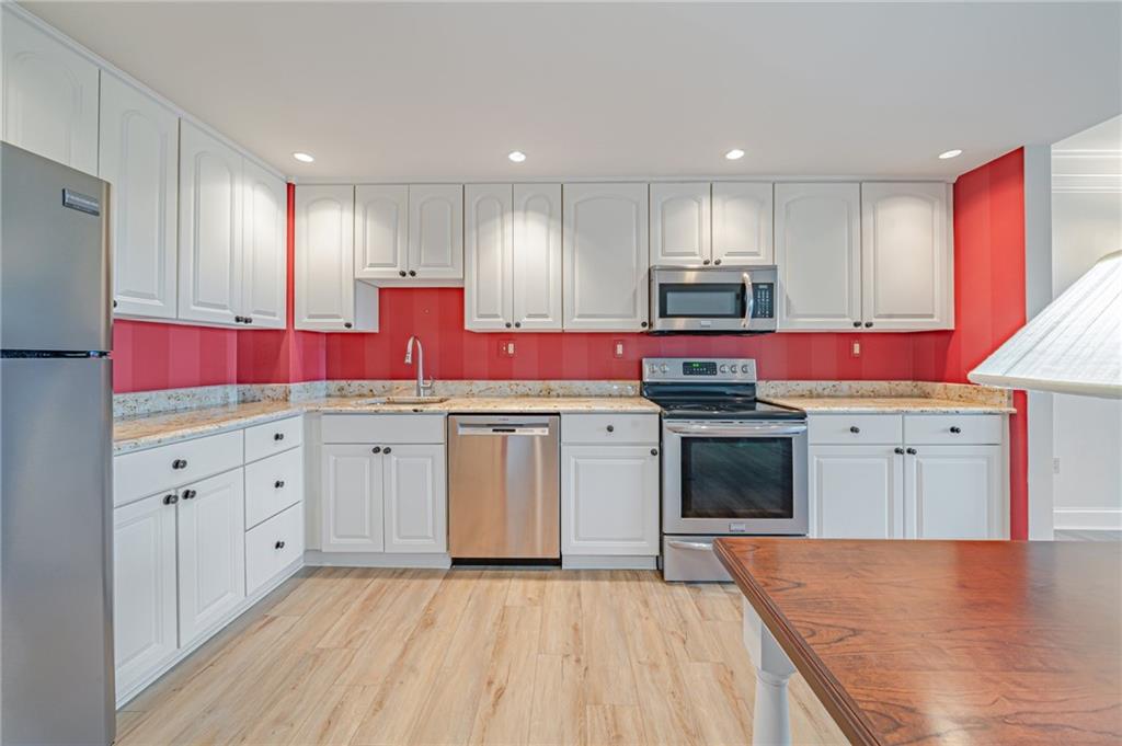 750 Washington Road, Unit 211 Pittsburgh, PA 15228 - Photo 4 of 19 a kitchen with cabinets and white appliances