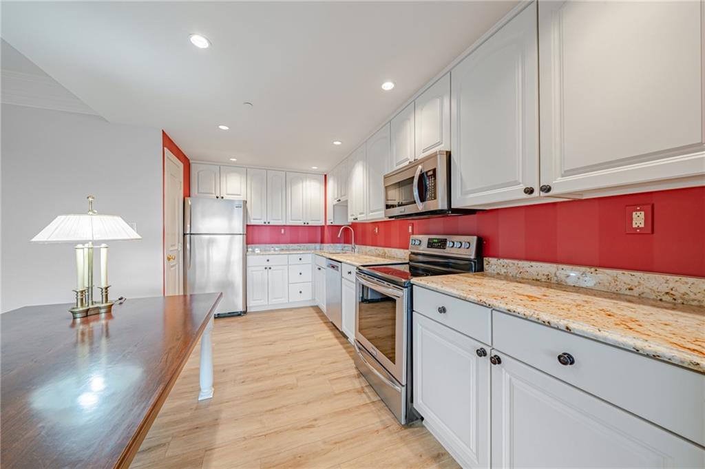 750 Washington Road, Unit 211 Pittsburgh, PA 15228 - Photo 5 of 19 a kitchen with stainless steel appliances granite countertop a sink and cabinets