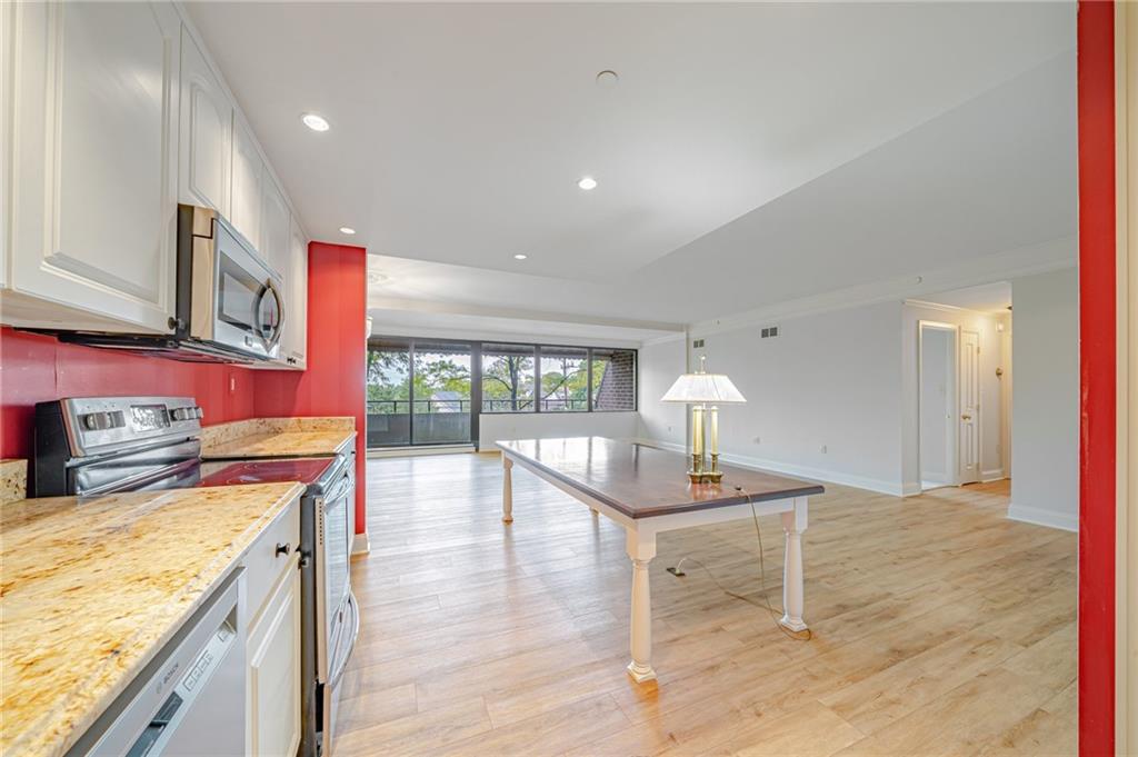 750 Washington Road, Unit 211 Pittsburgh, PA 15228 - Photo 6 of 19 a kitchen with a stove a sink a refrigerator and wooden cabinets