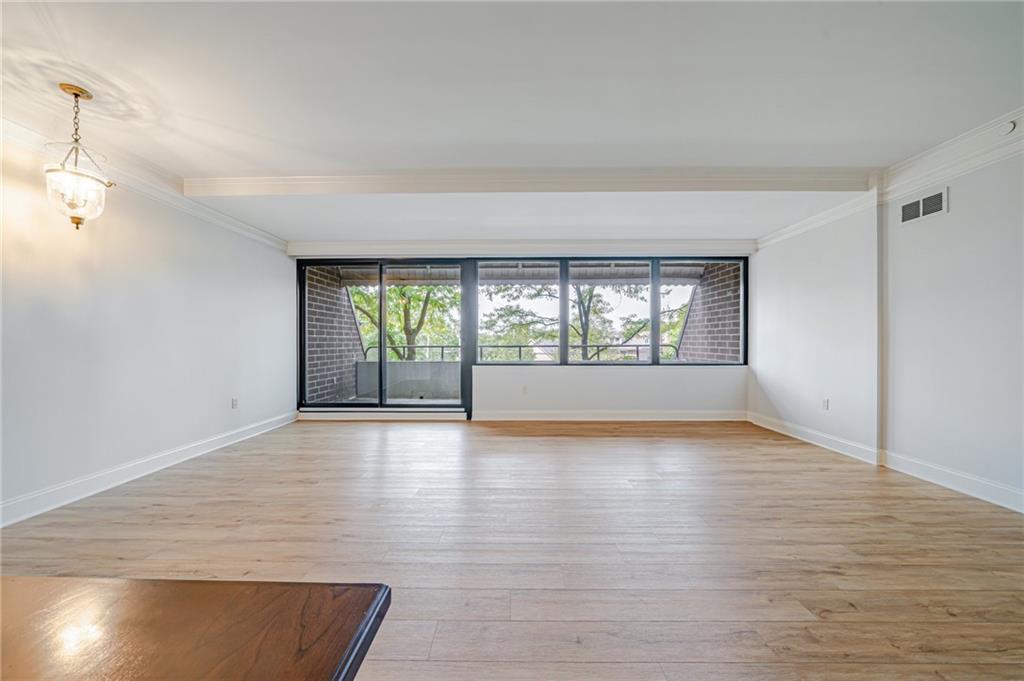750 Washington Road, Unit 211 Pittsburgh, PA 15228 - Photo 7 of 19 an empty room with wooden floor and windows