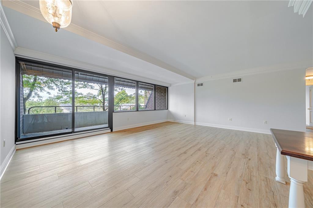 750 Washington Road, Unit 211 Pittsburgh, PA 15228 - Photo 9 of 19 wooden floor in an empty room with a window