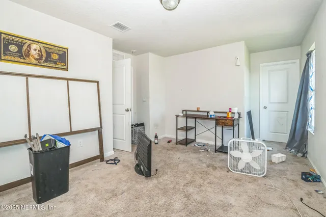 a view of work space with furniture and a gate