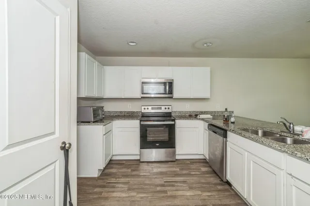 a kitchen with a sink and a stove top oven