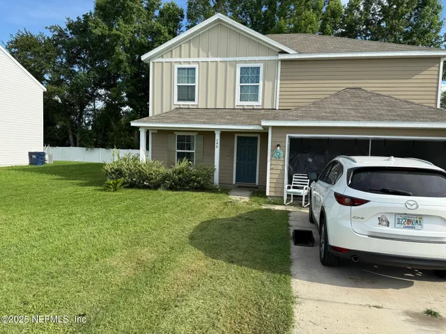 a front view of a house with a garden
