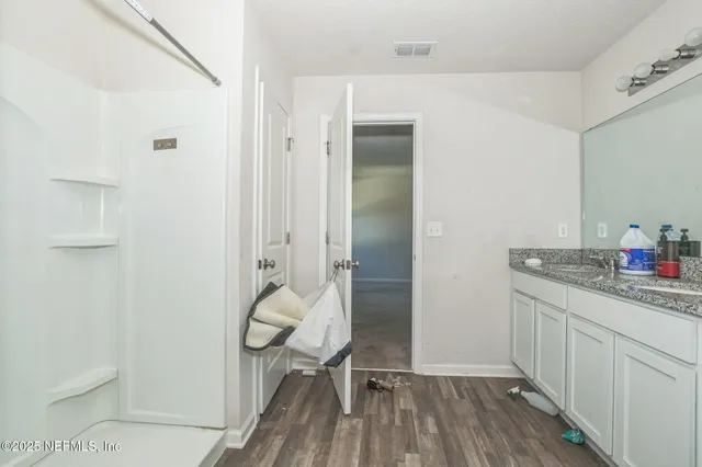 a kitchen with a sink and wooden floor