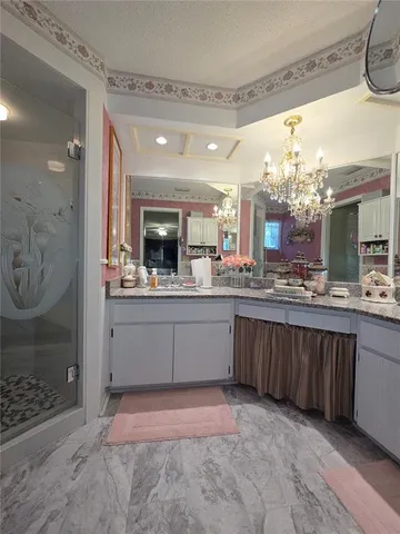 a large bathroom with a large mirror vanity and sink