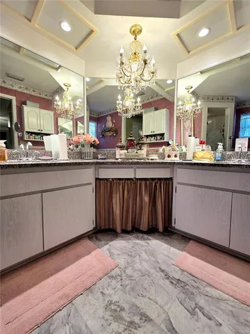 a kitchen with kitchen island granite countertop a sink cabinets and stainless steel appliances