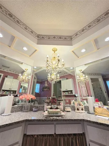 a kitchen with sink and view of living room