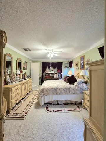 a spacious bedroom with a bed and cabinets