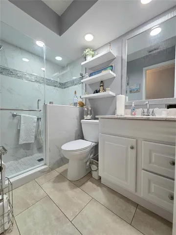 a spacious bathroom with a toilet sink and shower