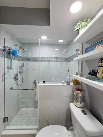 a bathroom with a toilet sink and shower