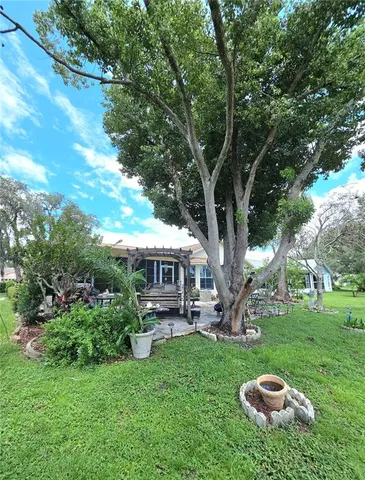 a view of a house with a backyard