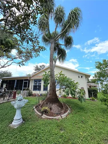 a front view of a house with a yard table and chairs