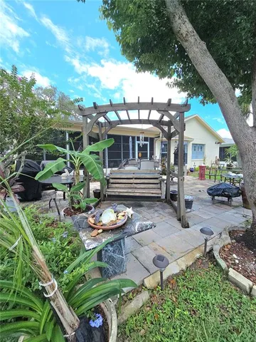 a view of a house with backyard and sitting area