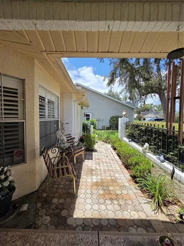 a view of a patio with table and chairs and potted plants