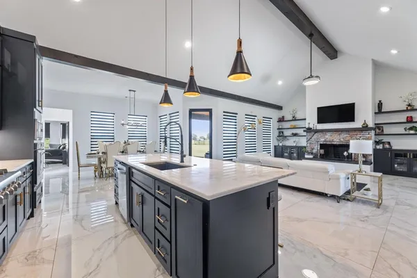 a kitchen with stainless steel appliances granite countertop a stove and a refrigerator