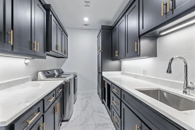 a kitchen with stainless steel appliances granite countertop a sink stove and cabinets