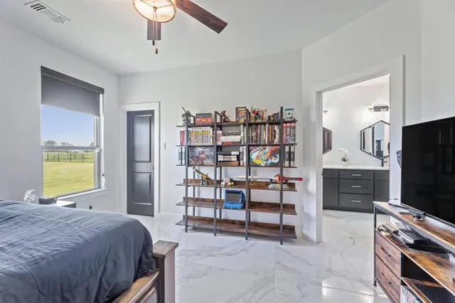 a bedroom with a bed furniture and a flat screen tv