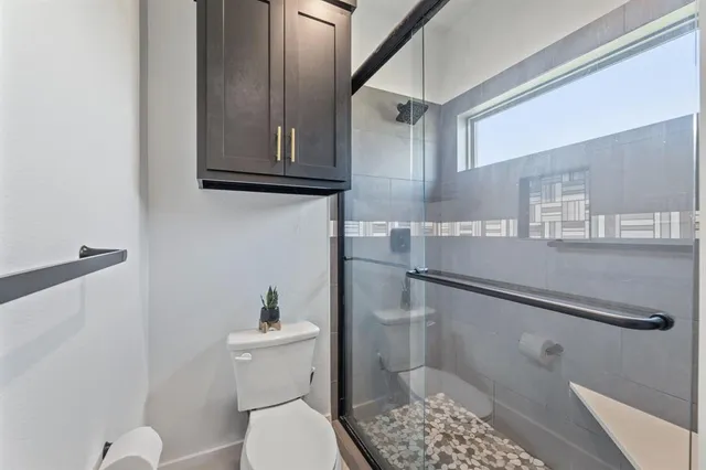 a bathroom with a toilet a sink and a shower