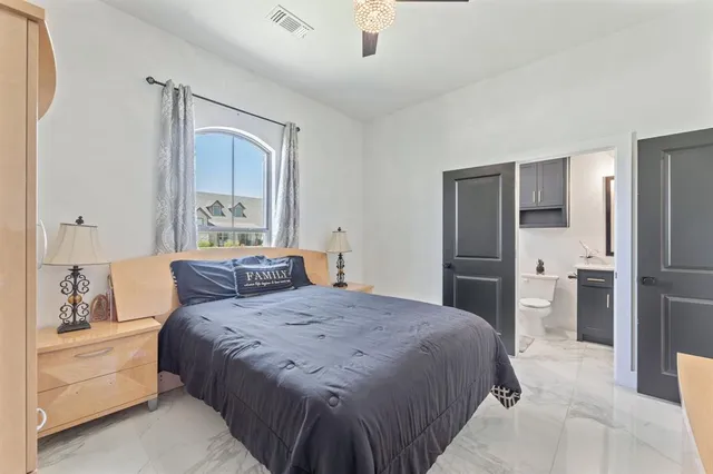 a bedroom with a large bed and a dresser