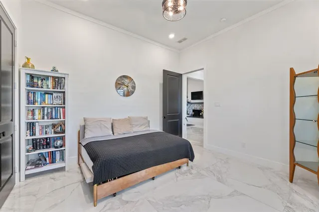 a bedroom with a bed and a book shelf